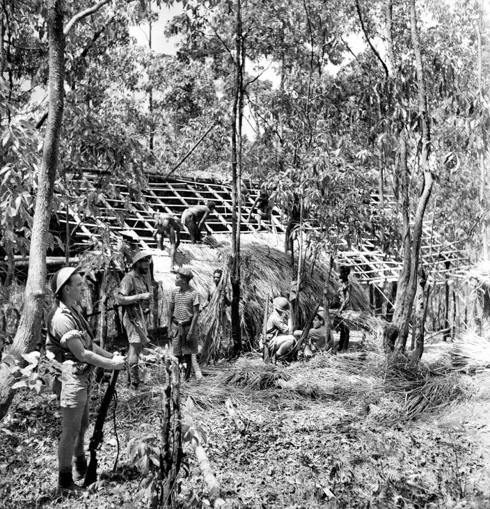 East Timorese constructing a hut for the use of Australian soldiers.